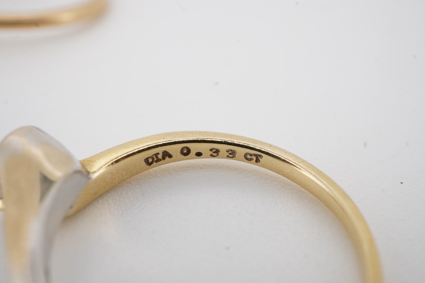 A modern two colour 18ct gold and solitaire diamond set ring, size N/O, the stone weight 0.33ct, together with a yellow metal and collet set solitaire diamond ring, size K, the stone weighing approximately 0.45ct, gross